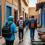 Home 20 우즈베키스탄 관광 필수 앱 - A vibrant street scene in historic Samarkand, Uzbekistan, showing a diverse group of tourists using ...
